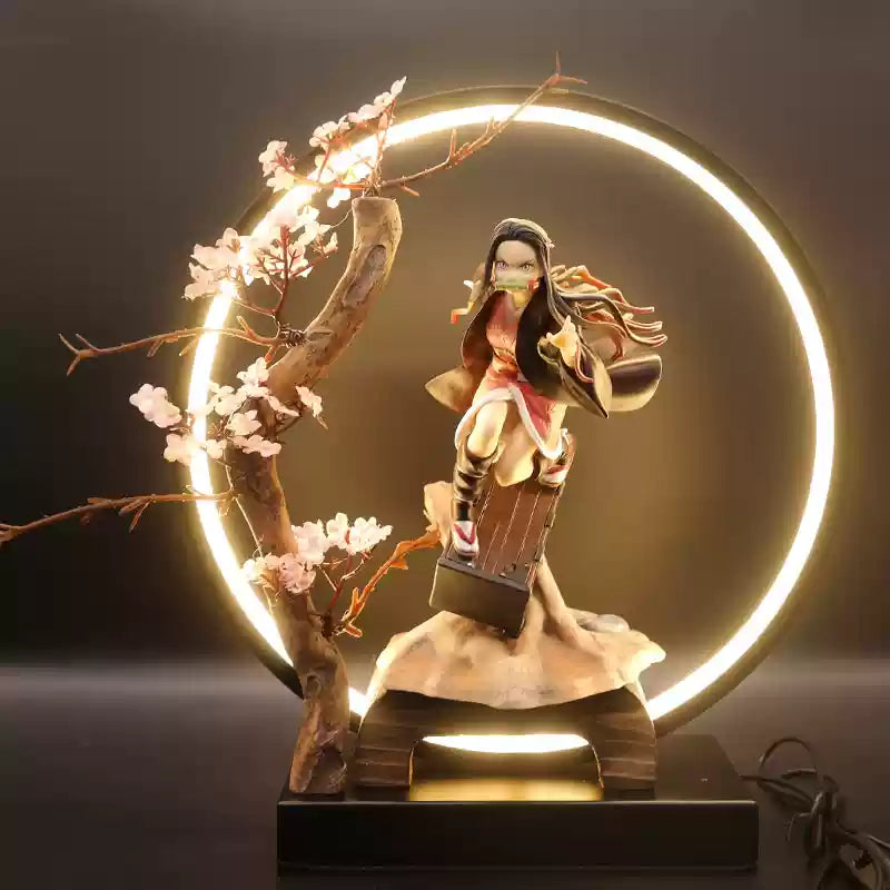 Demon Slayer Nezuko Kamado action figure in LED circular display with sakura tree, ideal for anime fans and collectors.