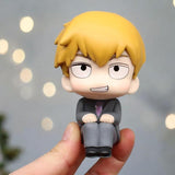 Cute chibi figure of Reigen from Mob Psycho 100 held in hand - perfect collectible for anime fans