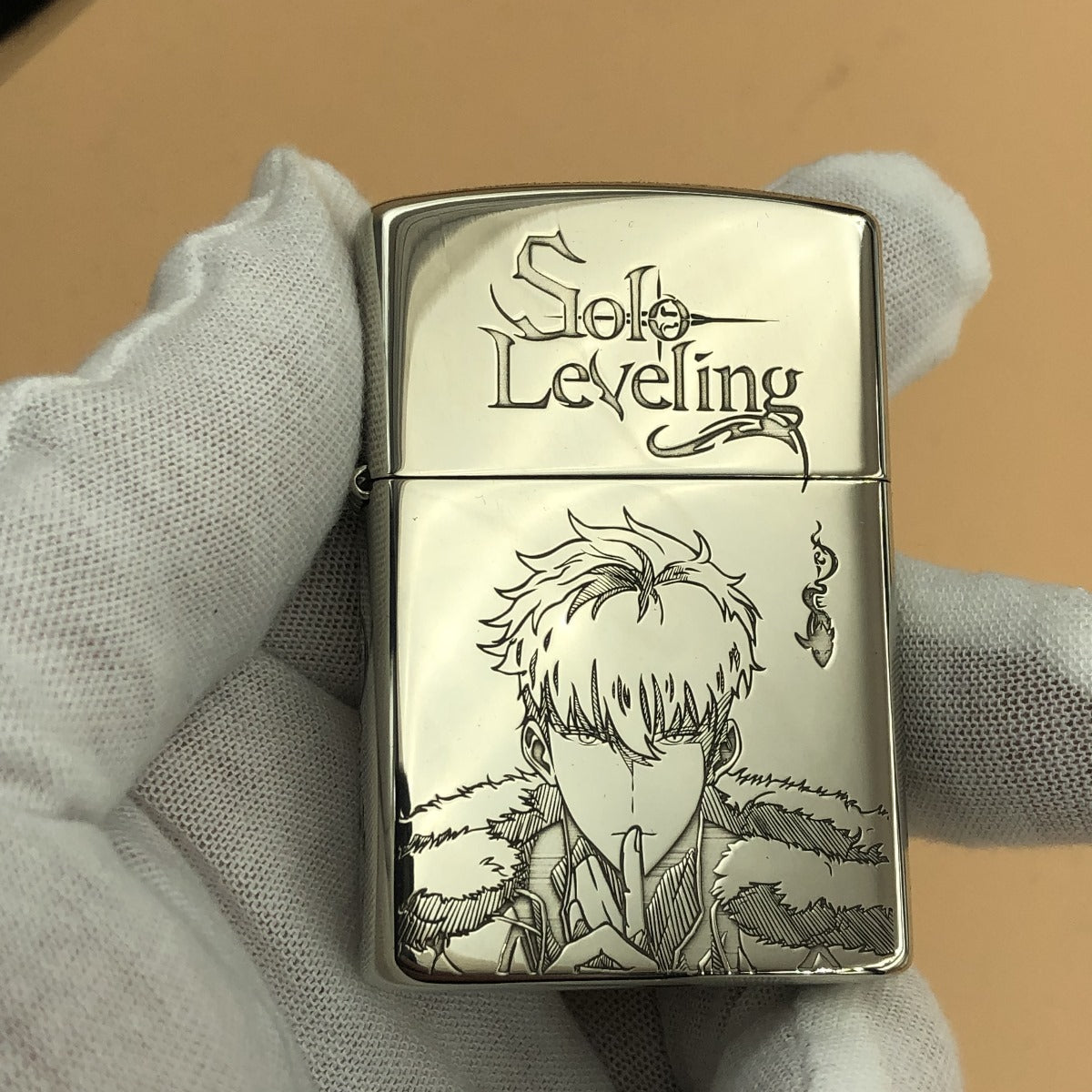 Front view of a Zippo lighter engraved with Sung Jin-Woo from the anime and manhwa Solo Leveling, featuring detailed artwork and the Solo Leveling logo.