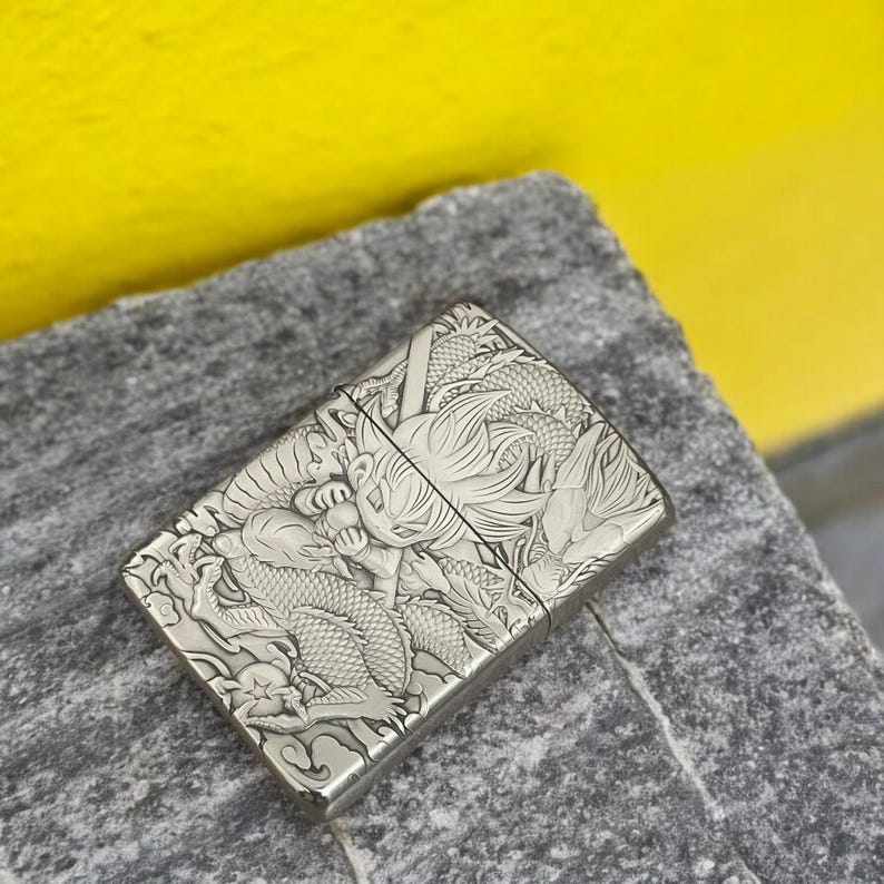 Angled view of Zorro 3D metal lighter featuring Goku from Dragon Ball and an intricate dragon design with detailed engraving.