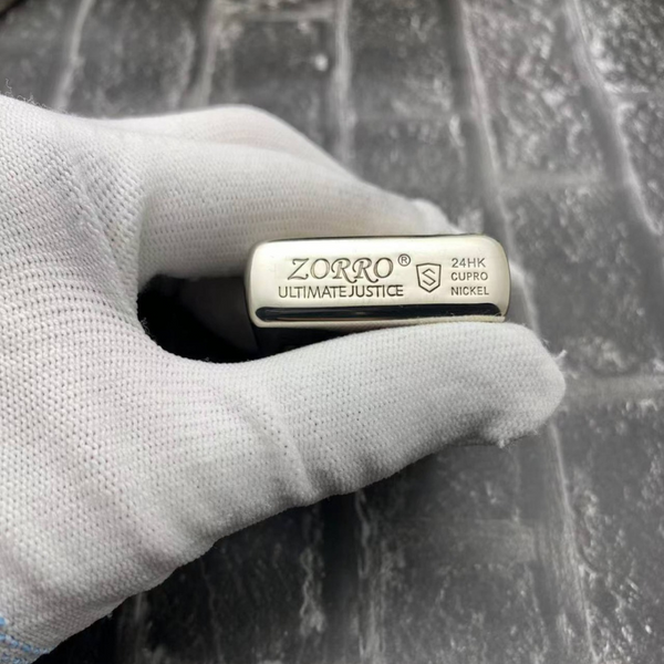 Bottom view of Zorro One Piece lighter showcasing the "Zorro Ultimate Justice" branding and premium 24HK cupro-nickel material details.